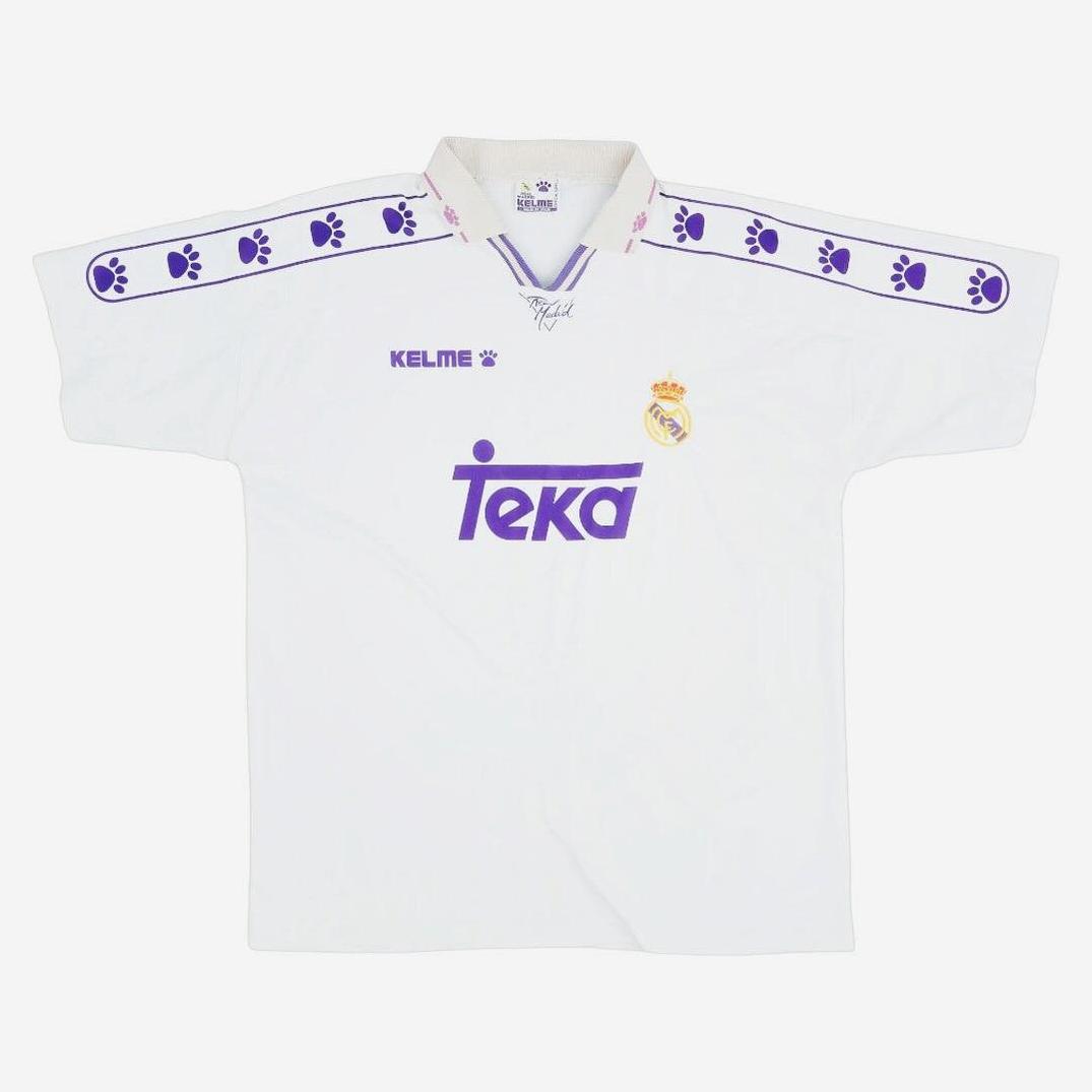 The Real Madrid 1994-96 Home Shirt by Retro1999 features classic purple trim, Kelme paw prints on the shoulders, a purple “Teka” sponsor, and the club crest—an iconic retro La Liga kit.