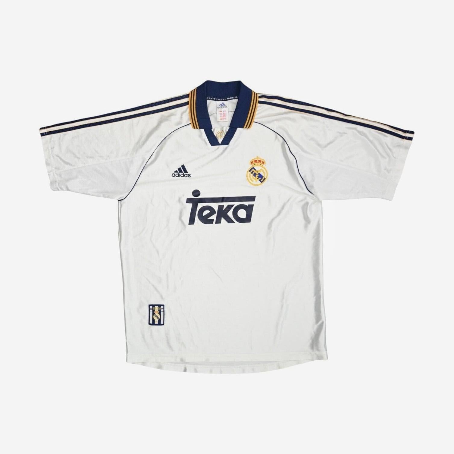 The Real Madrid 1999-00 Home Shirt by Retro1999 is white with navy and gold trim, navy shoulder stripes, a collared neckline, Teka sponsor, Adidas logo, and club crest for an authentic retro style.