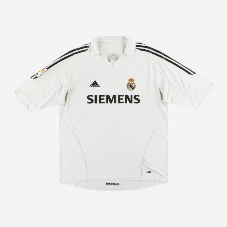 The Retro1999 Real Madrid 2005-06 Home Shirt is a white retro kit with black adidas stripes, Siemens sponsor on the front, and the club crest on the left chest for an authentic look.