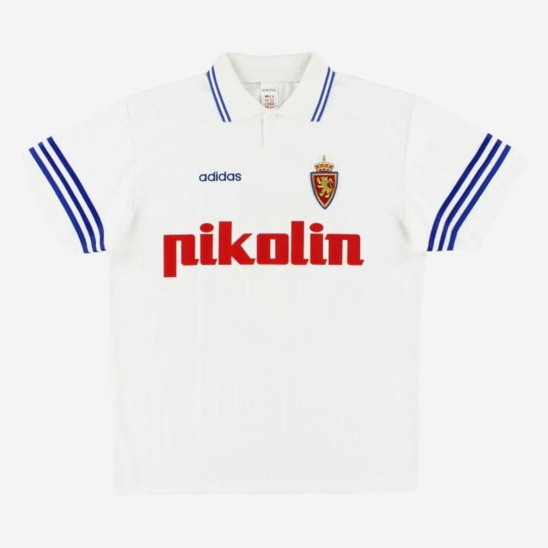 A white Retro1999 Real Zaragoza 1995-96 Home Shirt featuring blue Adidas stripes, the Zaragoza crest on the chest, and pikolín in red.