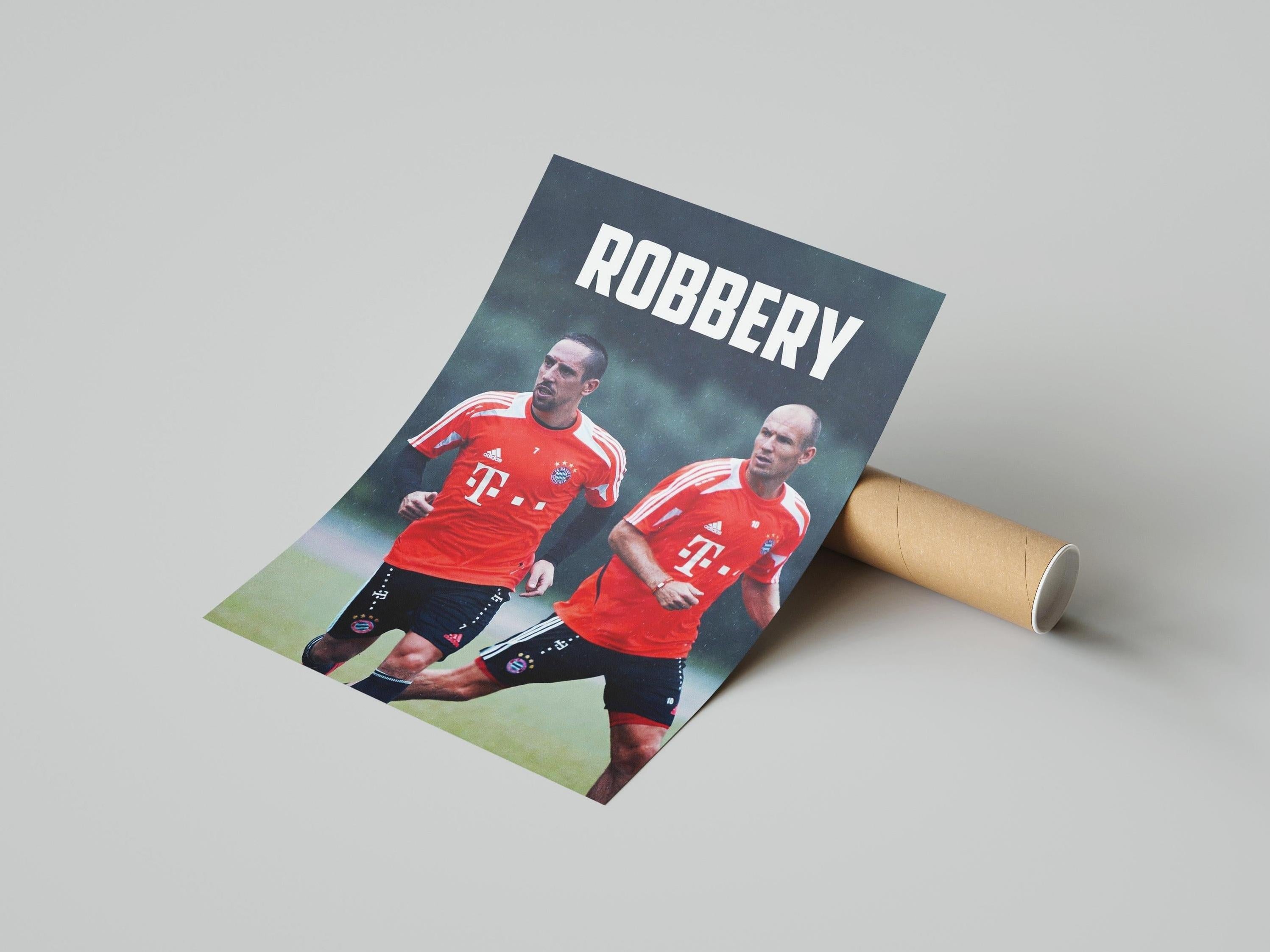 The Retro1999 Robben x Ribery ROBBERY Poster shows two Bayern Munich stars in red jerseys with ROBBERY at the top, partially unrolled from a cardboard tube on a light gray surface.