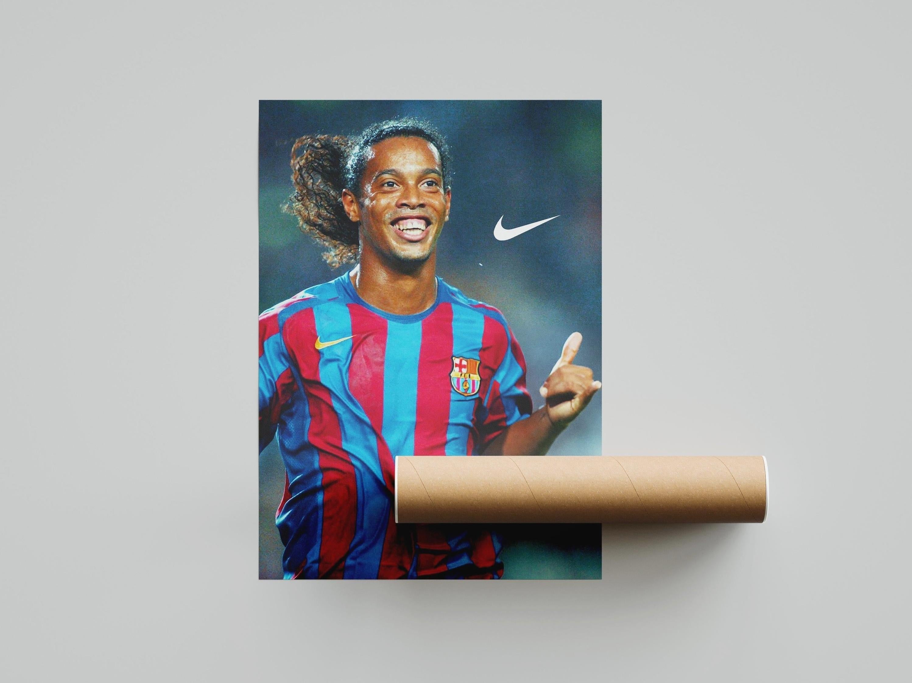 The Ronaldinho Gaucho x Barcelona Poster by Retro1999 features the soccer legend smiling in an FC Barcelona jersey with a Nike logo—ideal football memorabilia for any fan.