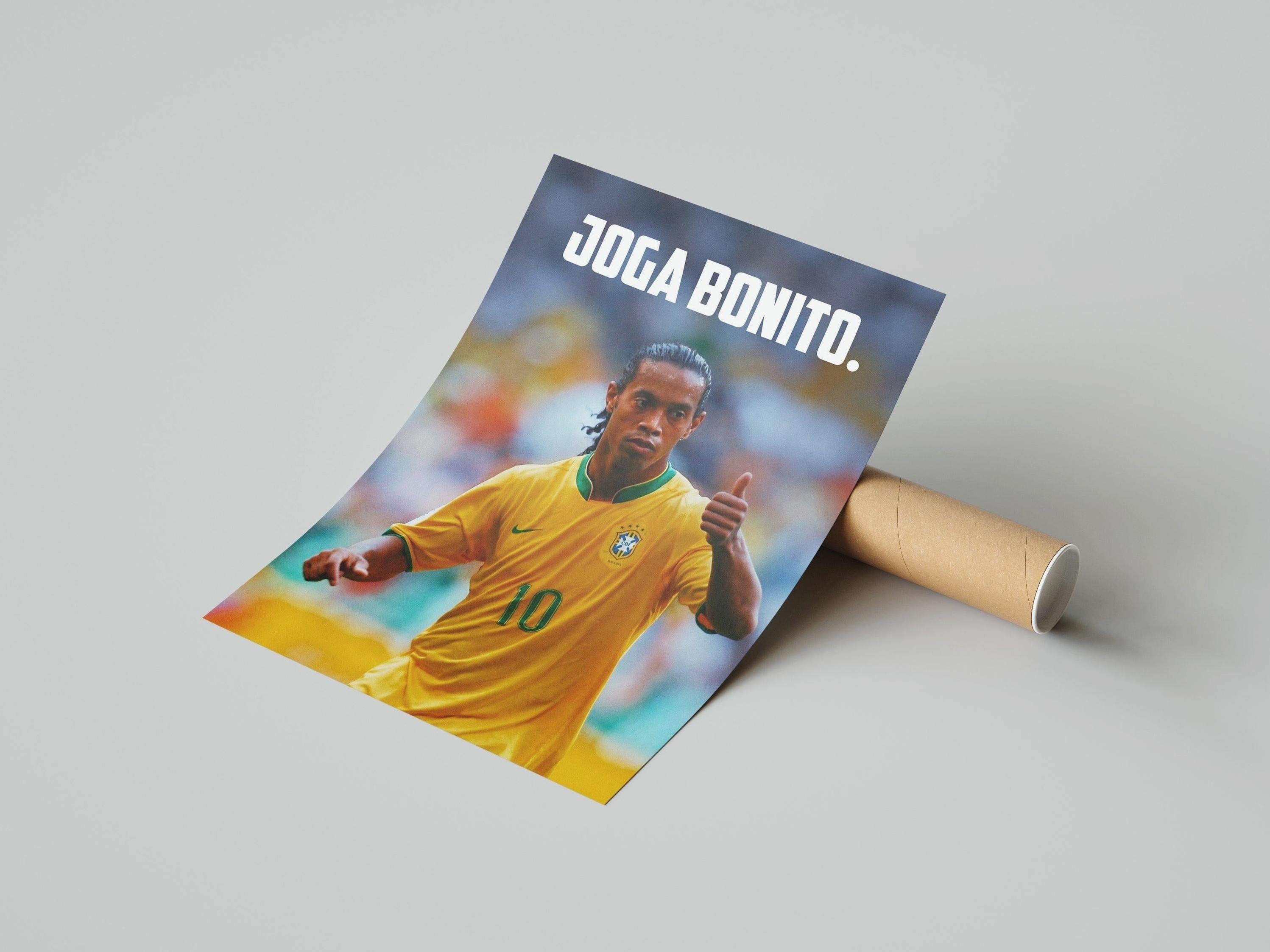 The Retro1999 Ronaldinho Joga Bonito Poster features the soccer star in Brazils yellow #10 jersey, giving a thumbs-up, with JOGA BONITO. at the top, celebrating the 2006 FIFA World Cup spirit. Rolled for easy display.