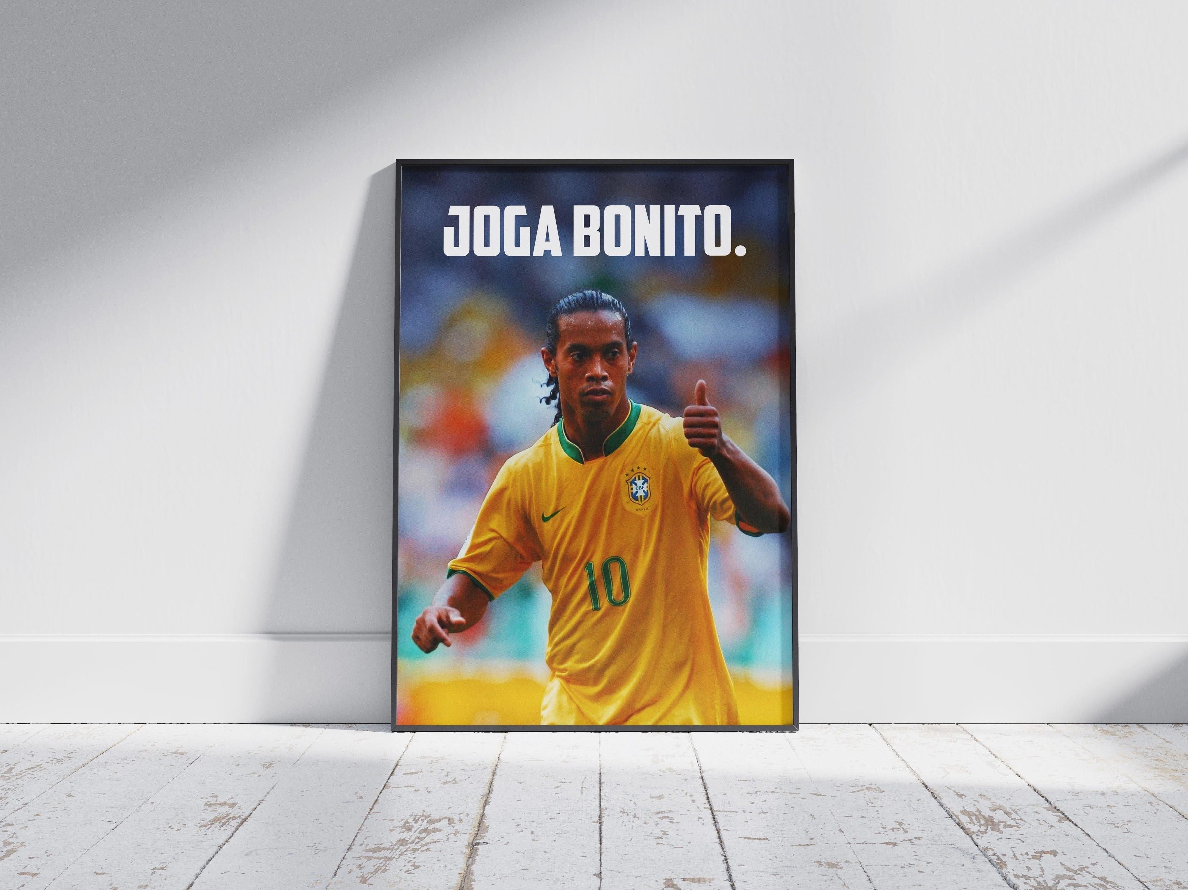 The Retro1999 Ronaldinho Joga Bonito Poster features the Brazilian star in a yellow jersey giving a thumbs up, with bold white JOGA BONITO. text above—perfect for fans of iconic FIFA World Cup 2006 style.