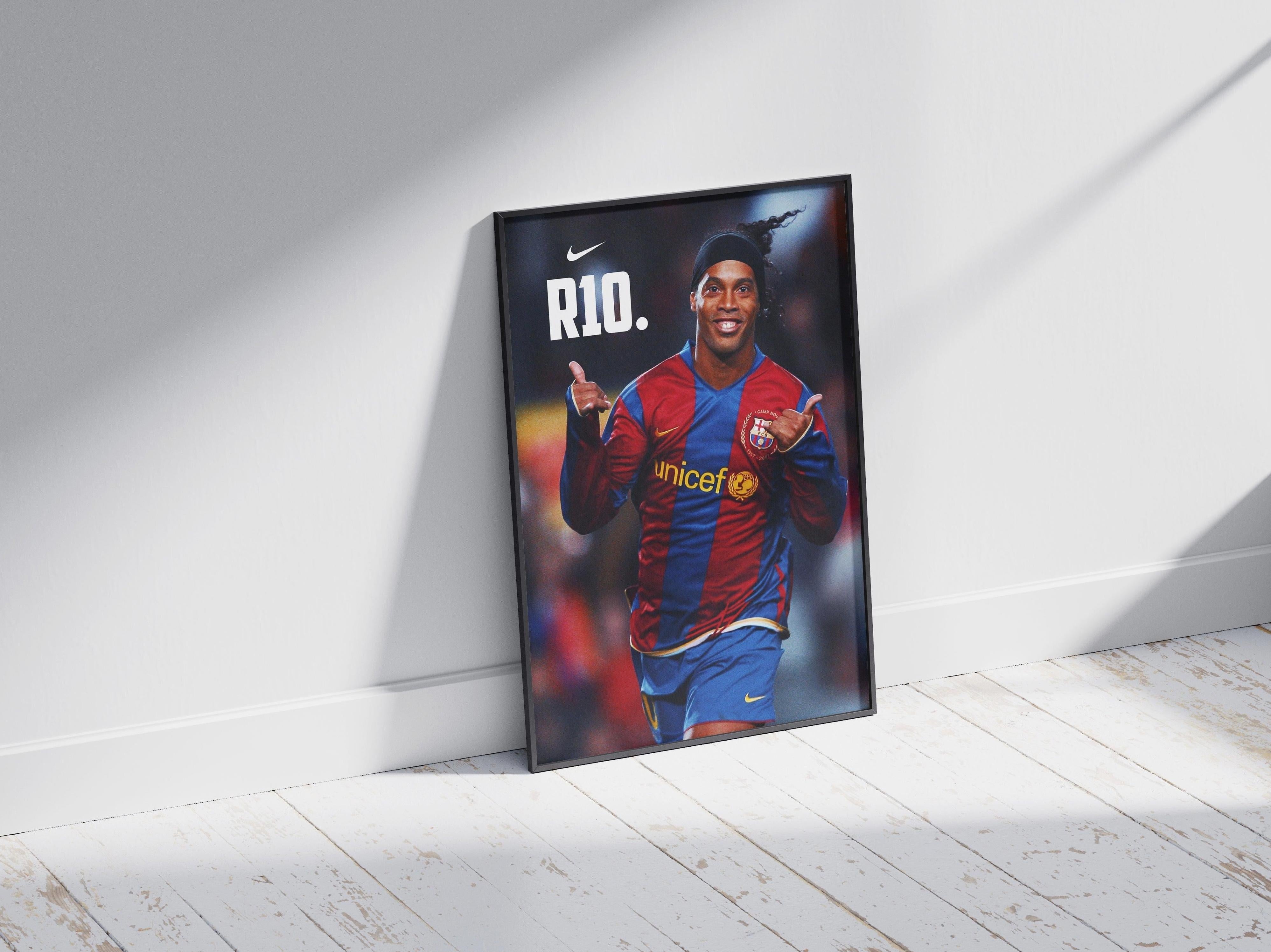 The Retro1999 Ronaldinho R10 Poster features the soccer legend smiling in a red and blue jersey with “R10.” and a Nike logo above—ideal as a football collectible or sports decor for any fan.