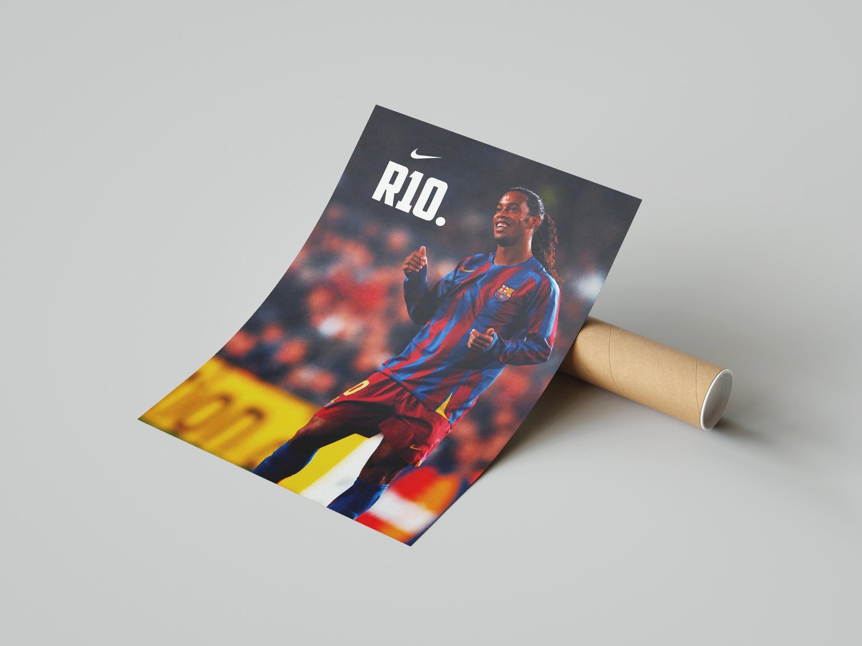 The Ronaldinho R10 Poster by Retro1999 features the soccer legend smiling on the field in a blue and red striped jersey, with “RIO.” and a white Nike logo above—ideal for football enthusiasts and UEFA Champions League fans.