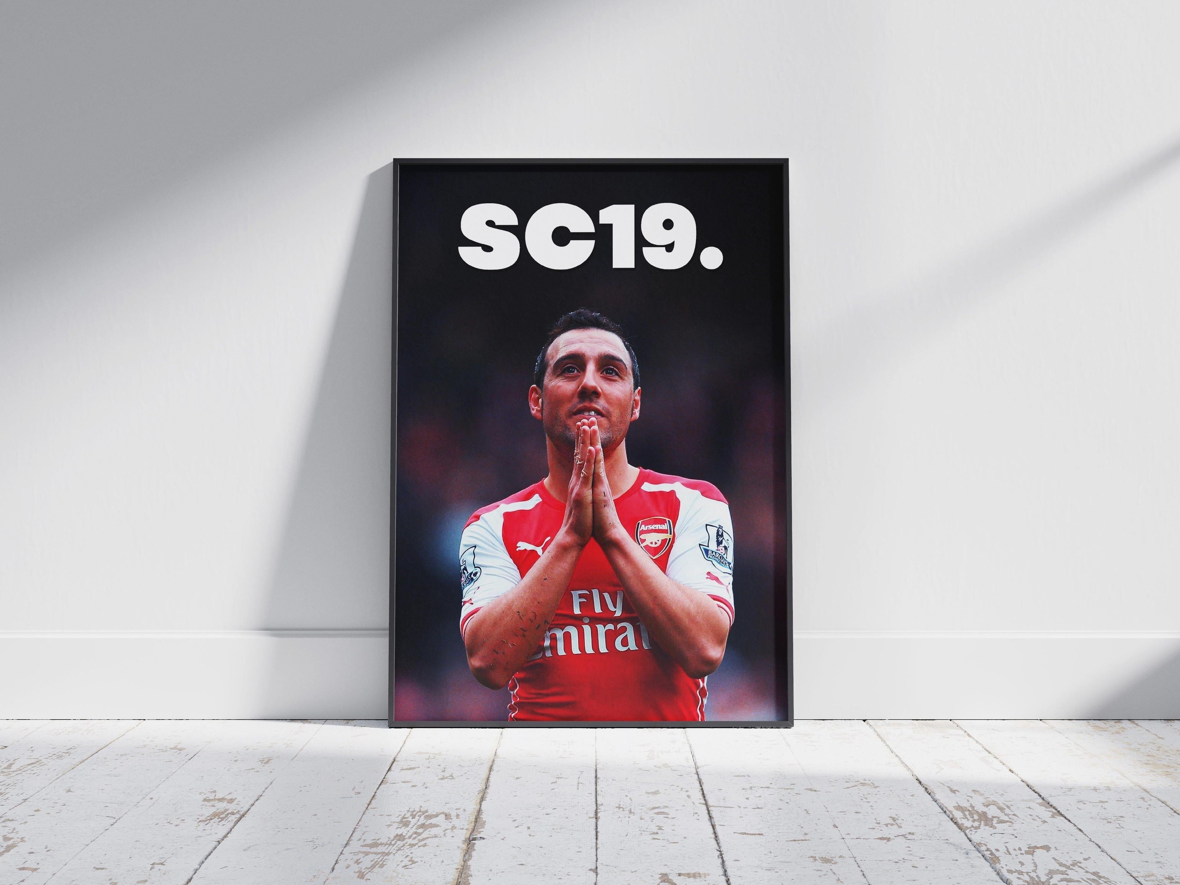The Retro1999 Santi Cazorla SC19 Poster features the footballer in an Arsenal jersey, hands clasped and looking up, with bold white SC19 text above—an iconic tribute to his Barclays Premier League legacy.
