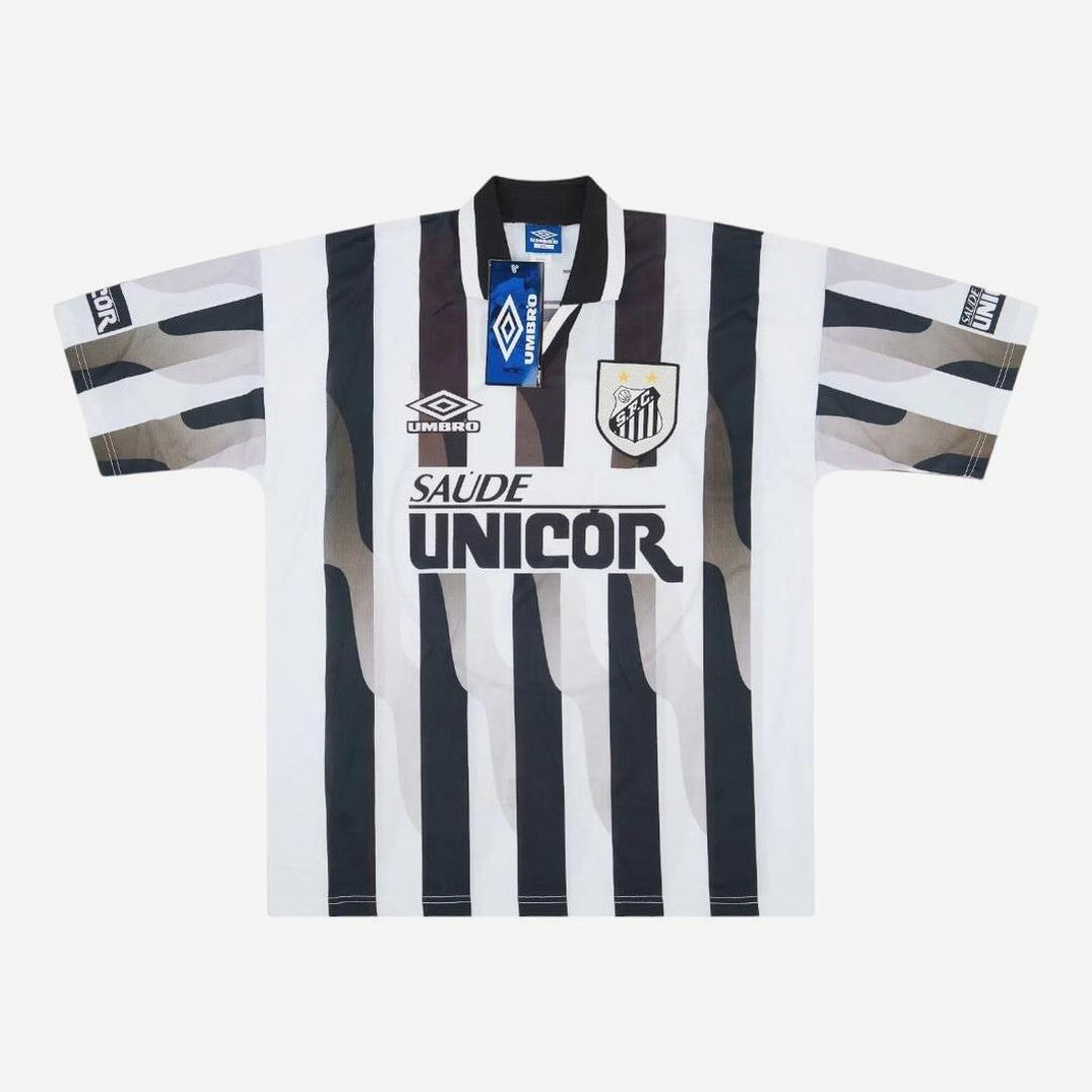The Santos 1998 Away Shirt by Retro1999 features black and white vertical stripes, Umbro and club logos, Saúde Unicor sponsor, a collar, and attached tags—a classic standout for retro kit collectors.