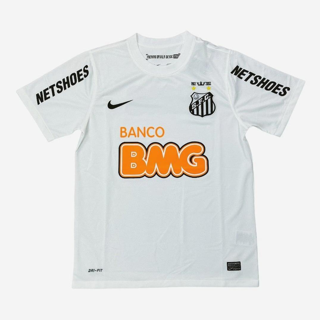 The Santos 2012-2013 Home Shirt by Retro1999 features black NETSHOES text on the shoulders, club crest and Nike logo on the chest, and orange BANCO BMG—a classic linked to Neymar and rich Brazilian football history.