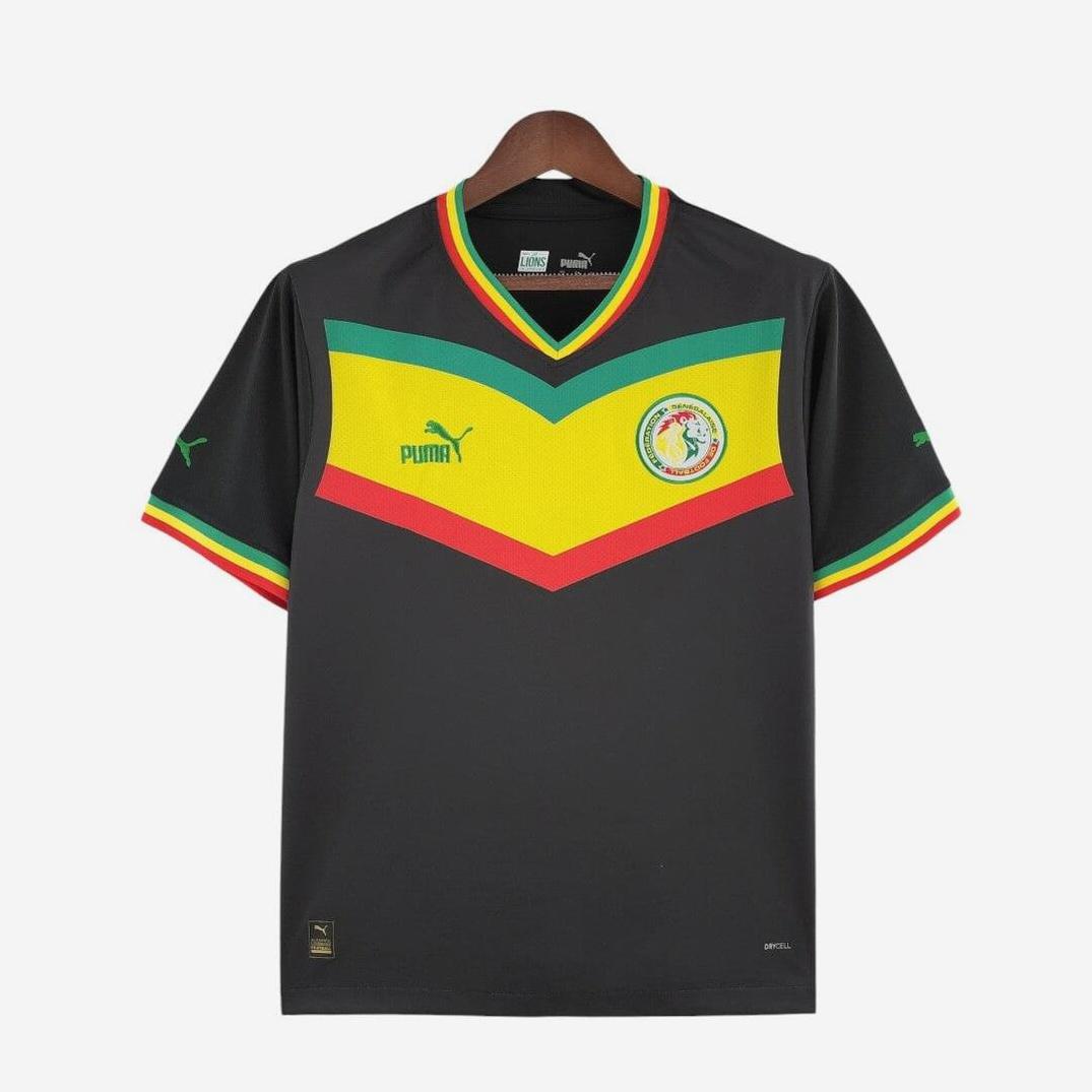 The Retro1999 Senegal 2022 Away Shirt is black with yellow, green, and red chest stripes, plus authentic collar and sleeve details in vibrant national colors. Features the national team crest.
