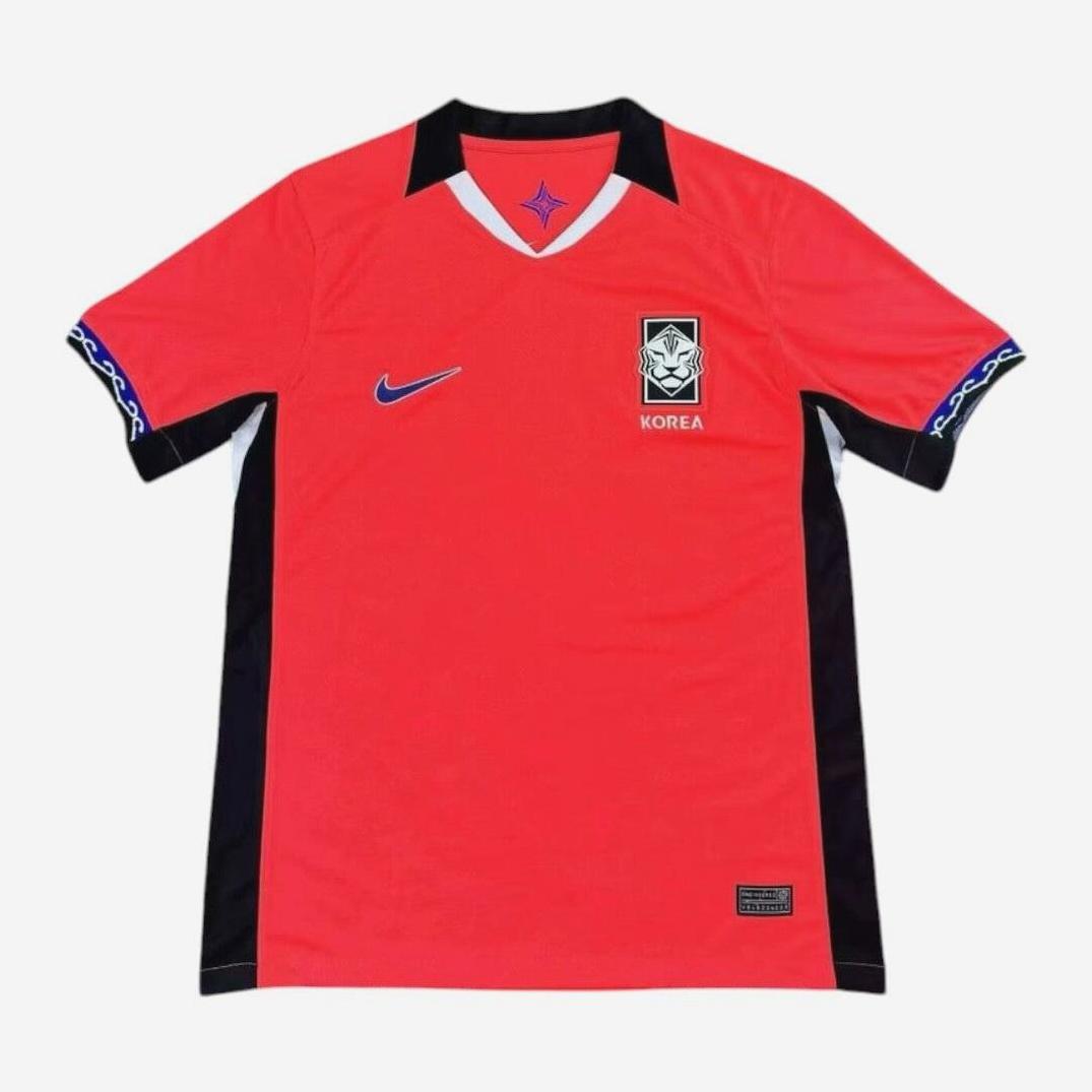 The South Korea 2025-26 Home Shirt by Retro1999 is a retro-inspired red jersey with black side panels, a blue Nike logo, the Korea Football Association crest, blue collar, and patterned sleeve strips—ideal fan gear for supporters.