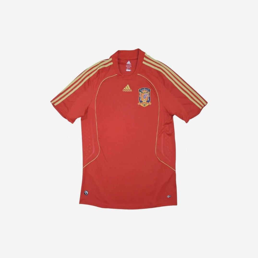 A Spain 2008 Home Shirt by Retro1999, in red with yellow shoulder stripes, Spanish National Team crest on the left chest, and adidas logo on the right—an iconic retro kit shown flat on a white background.
