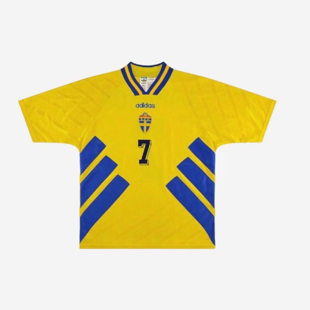 A yellow Retro1999 Sweden 1994 Home Shirt with blue accents, Swedish crest, number 7 on the front, blue diagonal stripes, and a V-neck collar—retro-inspired soccer jersey.