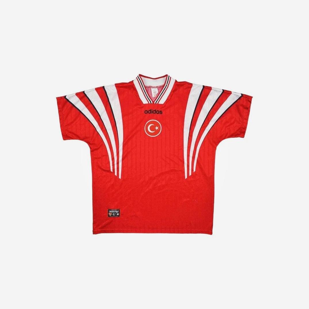 A Turkey 1990 Home Shirt by Retro1999 in red, featuring white and black shoulder stripes, the Turkish crescent and star emblem on the chest, a striped collar, shown on a plain white background.