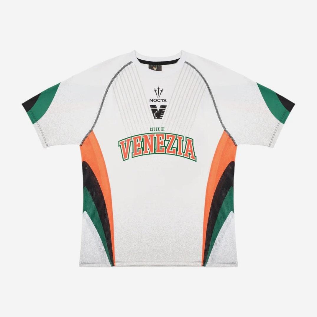 The Retro1999 Venezia 2024-25 Away Shirt features a white base with green, orange, and black accents, bold VENEZIA text, logos above, and geometric sleeve patterns for a classic retro Serie A style.